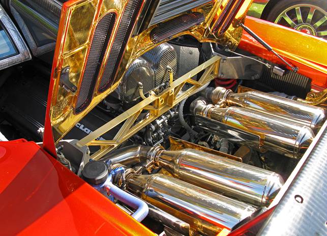 The McLaren F1's engine compartment contains the mid-mounted BMW S70/2 engine and uses gold foil as a heat shield in the exhaust compartment.