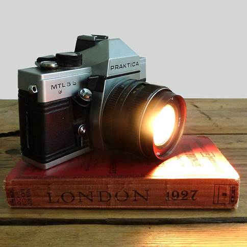 One of a range of 35mm SIR cameras lovingly repurposed into quirky desk lamps, this Praktica now emits light rather than capturing it. 