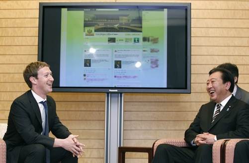 Description: Facebook CEO Mark Zuckerberg (L) speaks to Japan's Prime Minister Yoshihiko Noda (R)