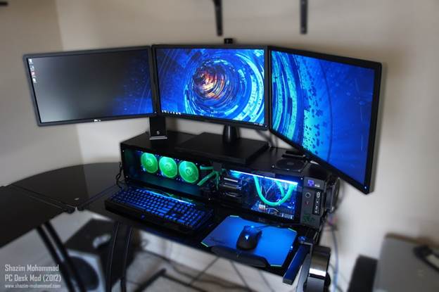 The system contains an Intel Core i5-2500k Processor with an Asus Gene IV Motherboard, AMD Radeon HD 7950 Graphics card, 3 x Dell Ultra Sharp 23inch monitors
, liquid cooling system, and more.
