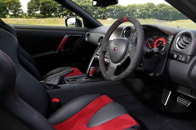 Interior trim features include red stitching on the seats, centre console, door trim and steering wheel