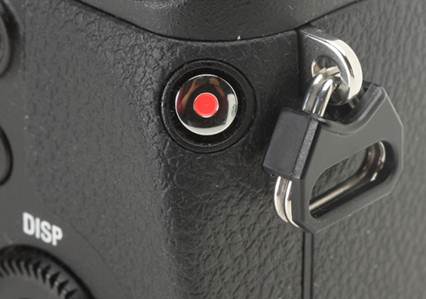 Description: The movie record button of the NEX-6 is placed concavely, somewhat awkwardly, along the right edge of the camera at a 45 degree angle. While requiring a hold of the camera with both hands, its position prevents wrong operation, which is a serious problem towards the NEX-7.